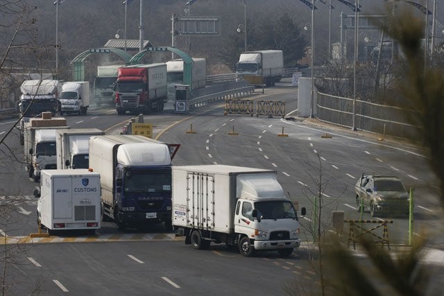 vehicles leaving the kaesong joint industrial zone pass through disinfectant spray before a checkpoint at the ciq immigration centre near the demilitarized zone dmz separating north an south korea in paju on february 11 2016 photo afp