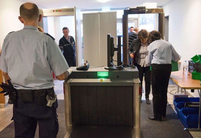 judiciary employees operate security controls ahead of a trial against a former auschwitz guard at the court in detmold western germany on february 11 2016 the 94 year old former auschwitz guard went on trial for complicity in the murders of tens of thousands of people at the nazi concentration camp photo afp