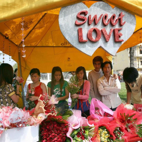 cambodian women prepare flowers for sale at a shop along a street in phnom penh on february 14 2008 photo afp cambodian women prepare flowers for sale at a shop along a street in phnom penh on february 14 2008 photo afp