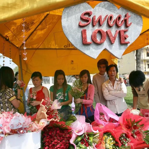 cambodian women prepare flowers for sale at a shop along a street in phnom penh on february 14 2008 photo afp cambodian women prepare flowers for sale at a shop along a street in phnom penh on february 14 2008 photo afp