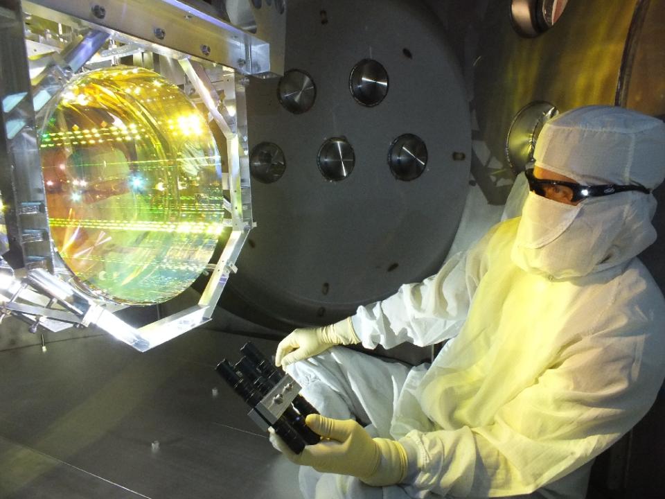 this image taken december 14 2015 shows a laser interferometer gravitational wave observatory ligo optics technician inspecting one of ligo 039 s core optics mirrors photo afp