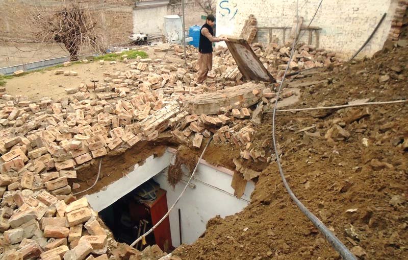 debris of the wall of a house that collapse in lower dir photo inp