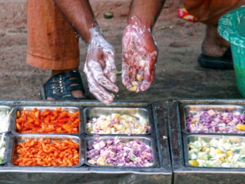 a man arranges a variety of salads in a tray the sindh govt plans to set up a food authority to ensure food quality standards photo file