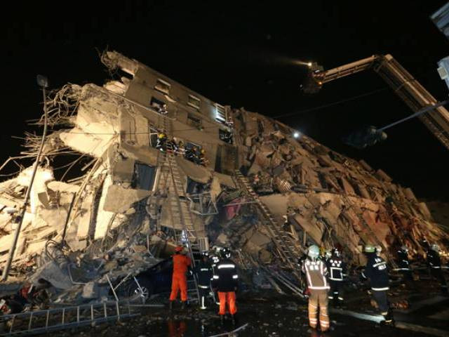 rescuers are seen entering an office building that collapsed on its side from an early morning earthquake in tainan southern taiwan on feb 6 2016 photo afp rescuers are seen entering an office building that collapsed on its side from an early morning earthquake in tainan southern taiwan on feb 6 2016 photo afp