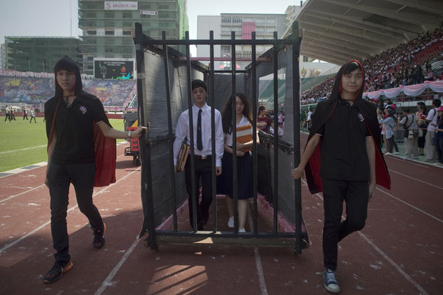 thai university students are seen inside a mock prison cell as they participate in a parade lampooning the military junta during a varsity football match at the national stadium in bangkok on february 13 2016 photo afp