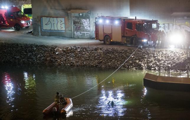service personnel repair a gate where a car drove through before crashing into the canal under the e4 highway bridge in sodertalje sweden february 13 2016 photo reuters