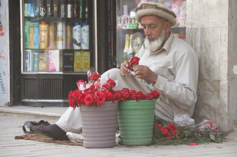 man sells flowers at a roadside in saddar bazaar in the city photo muhammad iqbal express