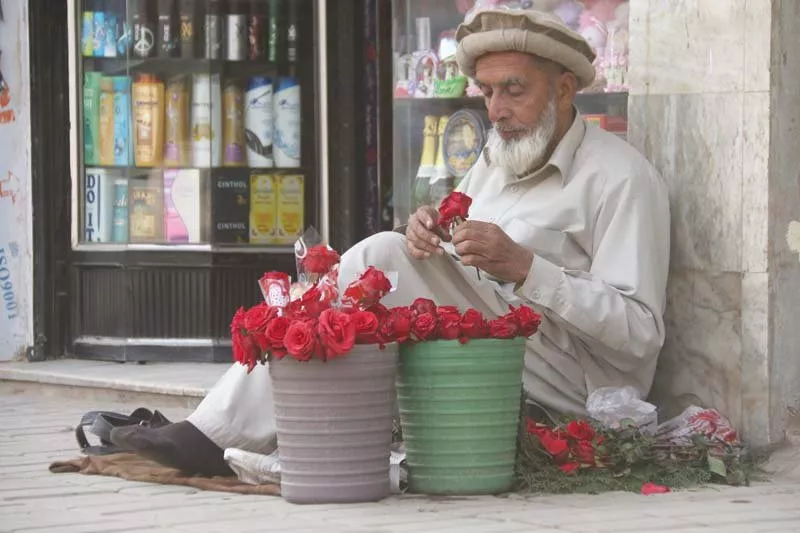 man sells flowers at a roadside in saddar bazaar in the city photo muhammad iqbal express man sells flowers at a roadside in saddar bazaar in the city photo muhammad iqbal express