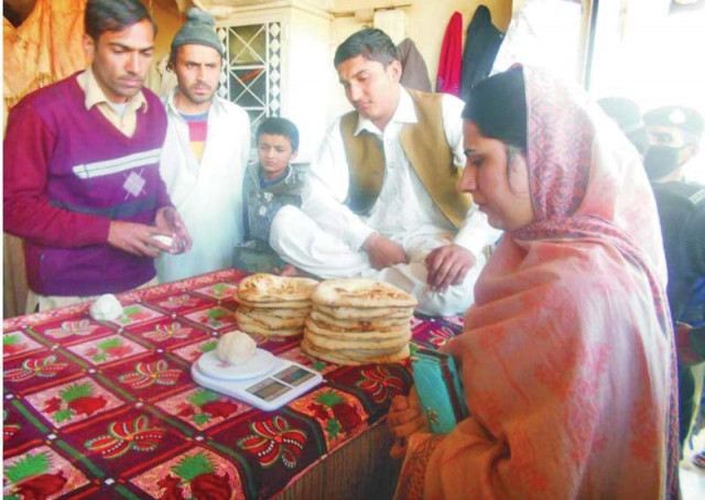 peshawar additional assistant commissioner fazilat jahan weighing nan dough following complaints from hayatabad photo courtesy dc office peshawar additional assistant commissioner fazilat jahan weighing nan dough following complaints from hayatabad photo courtesy dc office