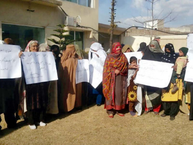 women hold banners and threaten to continue protest if demands not met photo express women hold banners and threaten to continue protest if demands not met photo express