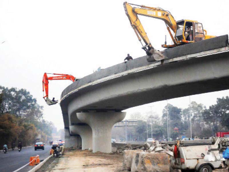 crane operators busy in work at the flyover photo wires