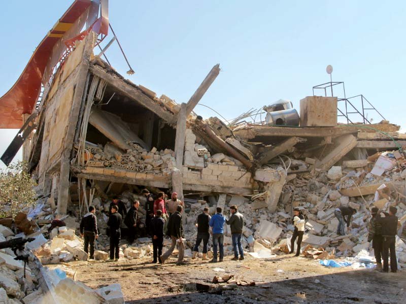 people gather around the rubble of a hospital supported by doctors without borders in syria s idlib province on monday after the building was hit by suspected russian air strikes photo afp