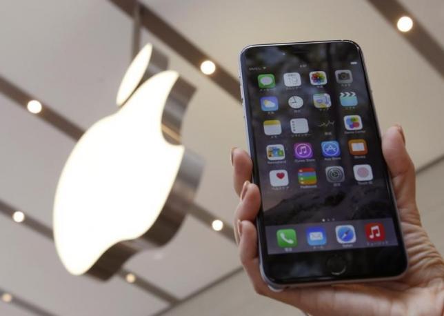 a woman holds up the iphone 6 plus at the apple store at tokyo 039 s omotesando shopping centre photo reuters