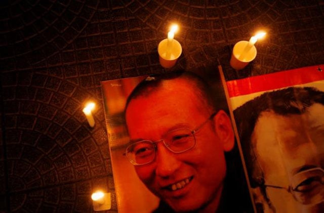 candles are placed around portraits of jailed chinese pro democracy activist liu xiaobo during a candlelight vigil demanding his release outside the legislative council in hong kong november 2 2010 photo reuters candles are placed around portraits of jailed chinese pro democracy activist liu xiaobo during a candlelight vigil demanding his release outside the legislative council in hong kong november 2 2010 photo reuters