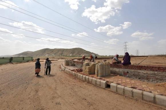 labourers work along the construction site of a road at ghilot in rajasthan october 1 2014 photo afp