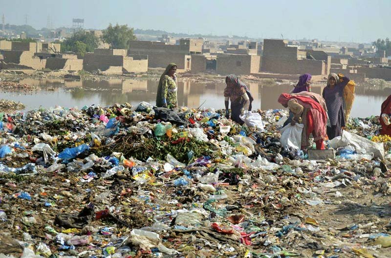 women look for valuables in a garbage dump at phuleli canal photo file