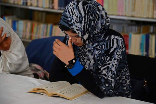 single women and housewives swaddled in brightly coloured headscarves come together in a basement room for the poetry reading some of them risking punishment or even death if discovered photo afp