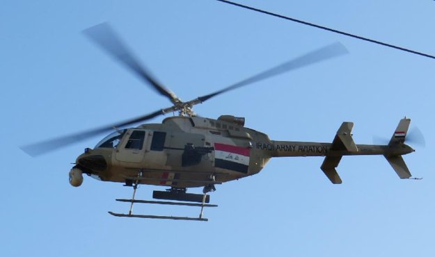 an iraqi army helicopter flies over the sufiya district on the outskirts of ramadi as security forces clear the area on january 15 2016 a few weeks after declaring victory against the islamic state group photo afp