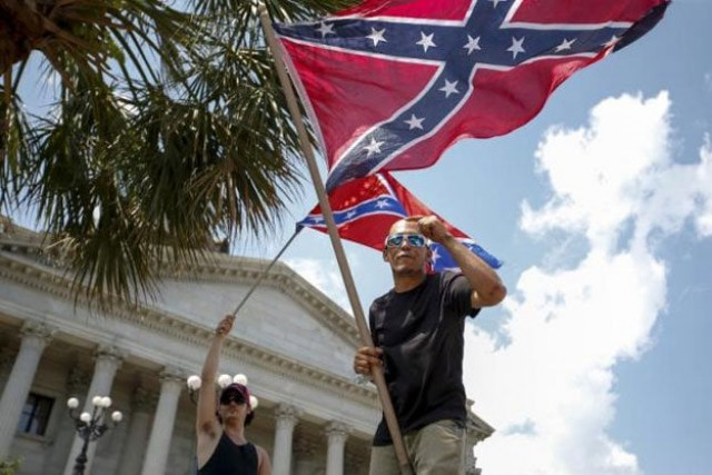ku klux klan supporters yell at opposing groups as they wave confederate flags during a rally at the statehouse in columbia south carolina july 18 2015 photo reuters
