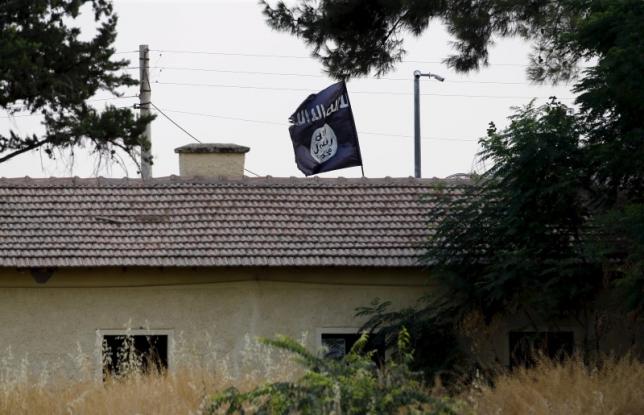 an islamic state flag flies over the custom office of syria 039 s jarablus border gate as it is pictured from the turkish town of karkamis in gaziantep province turkey in this august 1 2015 file photo photo reuters