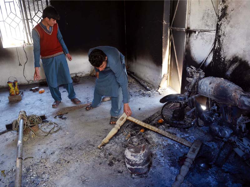 tribesmen sift through rubble inside a khasadar check post attacked in mohmand photo afp