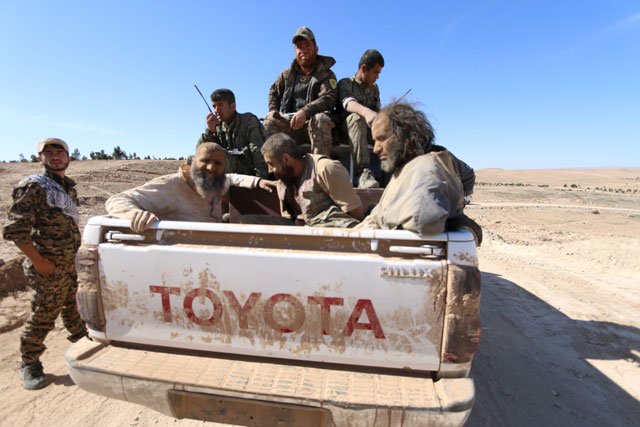 islamic state fighters sit on a pick up truck while being held as prisoners under democratic forces of syria fighters near al shadadi town hasaka countryside syria february 18 2016 photo reuters
