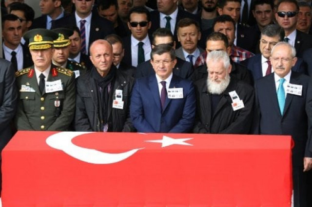 turkish prime minister ahmet davutoglu c stands behind the flag draped coffin of a car bombing victims during a funeral ceremony at kocatepe mosque in ankara on february 19 2016 photo afp