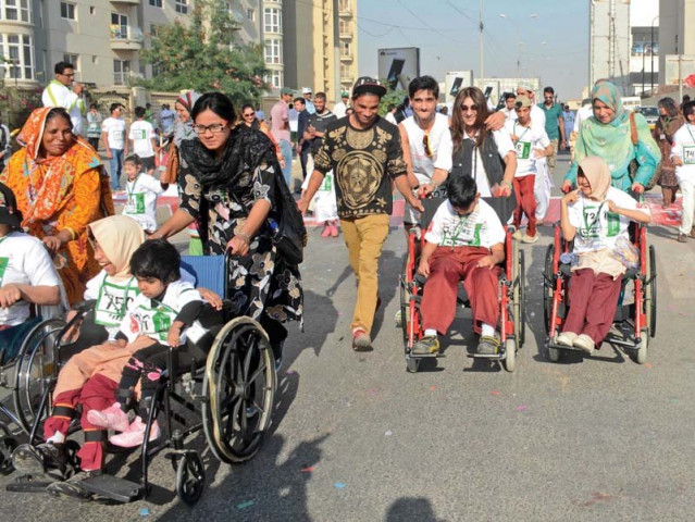 participants were seen running walking and rolling along in wheelchairs just so they could do their share for funding the special olympics pakistan photo rashid ajmeri express participants were seen running walking and rolling along in wheelchairs just so they could do their share for funding the special olympics pakistan photo rashid ajmeri express