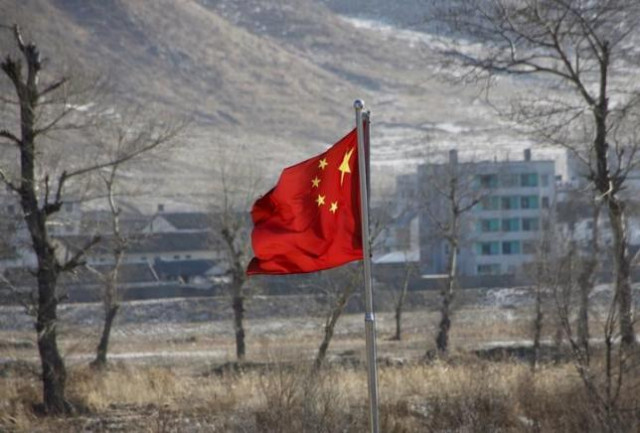 china 039 s national flag flutters on the chinese side of the banks of the tumen river as a north korean village is seen behind in tumen china january 7 2016 photo reuters china 039 s national flag flutters on the chinese side of the banks of the tumen river as a north korean village is seen behind in tumen china january 7 2016 photo reuters