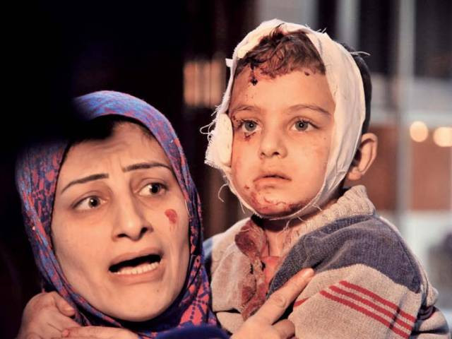 a distraught syrian woman holds her injured child close at a hospital after a bombing in damascus photo afp a distraught syrian woman holds her injured child close at a hospital after a bombing in damascus photo afp