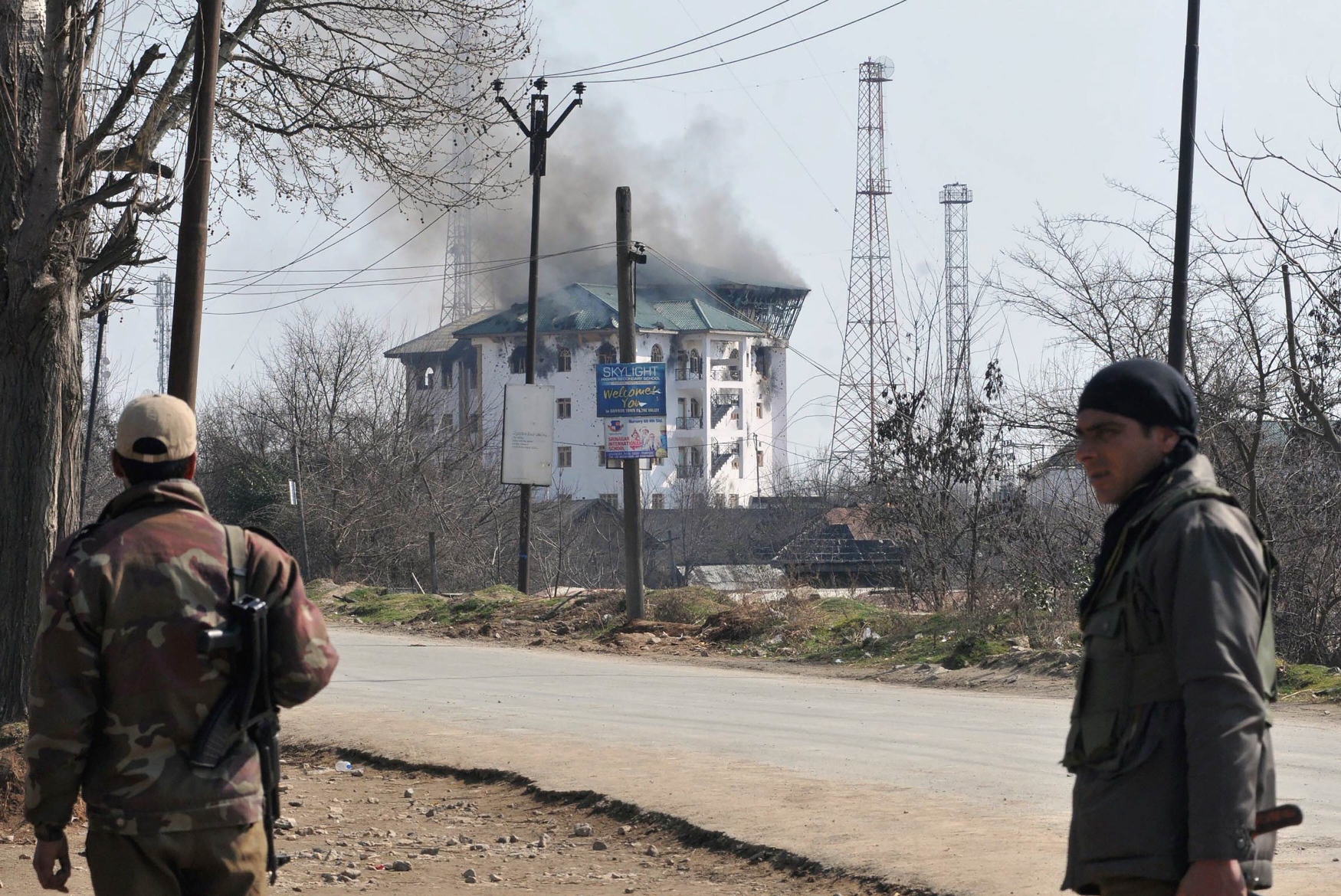 smoke rises from an indian government building where separatists took refuge during an ongoing gunbattle on the outskirts of srinagar on february 22 2016 photo afp