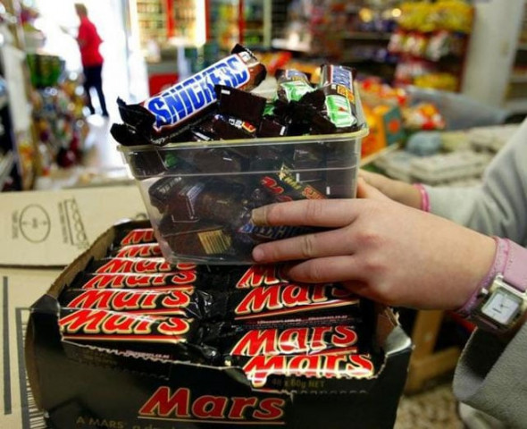 a shopkeeper removes mars bars and snickers bars from the shelves of her convenience store in the wake of a chocolate bar poison threat in sydney july 2 2005 photo reuters a shopkeeper removes mars bars and snickers bars from the shelves of her convenience store in the wake of a chocolate bar poison threat in sydney july 2 2005 photo reuters