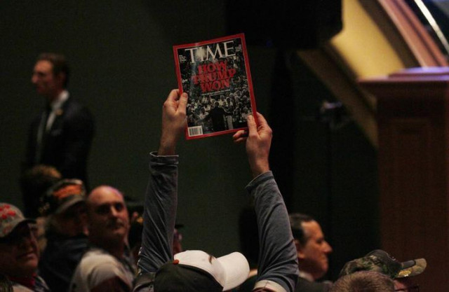 a supporter holds up a copy of time magazine during trump 039 s speech at a veteran 039 s rally in des moines iowa january 28 2016 photo reuters a supporter holds up a copy of time magazine during trump 039 s speech at a veteran 039 s rally in des moines iowa january 28 2016 photo reuters