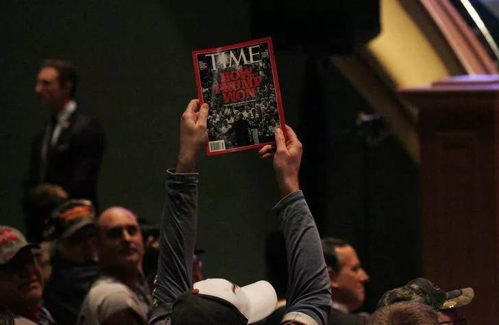 a supporter holds up a copy of time magazine during trump 039 s speech at a veteran 039 s rally in des moines iowa january 28 2016 photo reuters a supporter holds up a copy of time magazine during trump 039 s speech at a veteran 039 s rally in des moines iowa january 28 2016 photo reuters