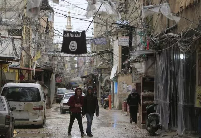 youth walk under an islamic state flag in ain al hilweh palestinian refugee camp near the port city of sidon southern lebanon january 19 2016 photo reuters youth walk under an islamic state flag in ain al hilweh palestinian refugee camp near the port city of sidon southern lebanon january 19 2016 photo reuters
