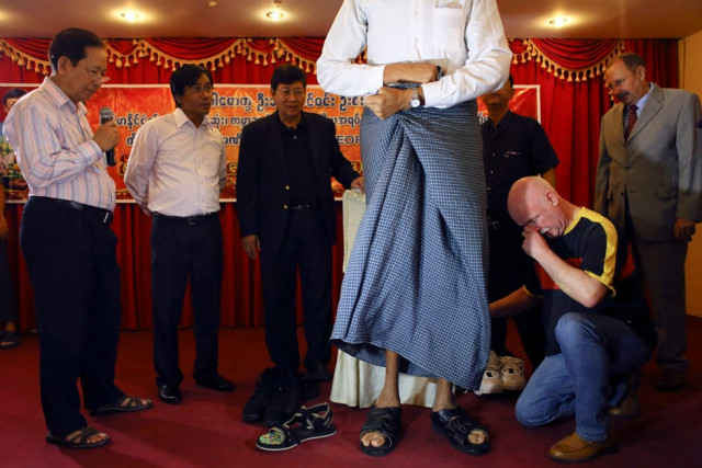 german shoemaker georg wessels helps win zaw oo who according to his medical team at 7 5 ft is myanmar 039 s tallest man in yangon march 26 2014 photo reuters german shoemaker georg wessels helps win zaw oo who according to his medical team at 7 5 ft is myanmar 039 s tallest man in yangon march 26 2014 photo reuters