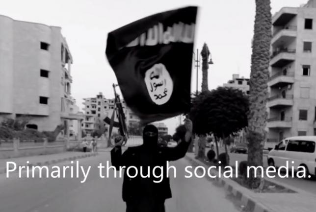 a member loyal to the islamic state in iraq and the levant waves an isil flag in raqqa syria on june 29 2014 in a still image taken from video produced by the student group 7strong photo reuters