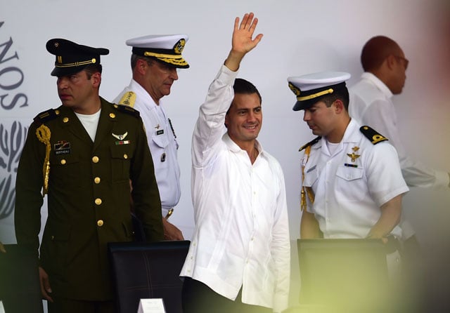 mexican president enrique pena nieto c waves during an event for the national flag day in iguala guerrero state mexico on february 24 2016 photo afp