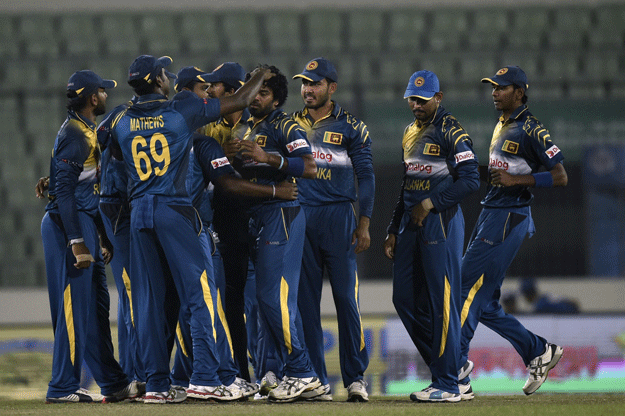 sri lankan cricketers congratulate their captain lasith malinga c at the sher e bangla national cricket stadium in dhaka on february 25 2016 photo afp