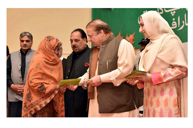 pm nawaz gives health card to a deserving lady at the launch of national health programme in aj amp k photo nni