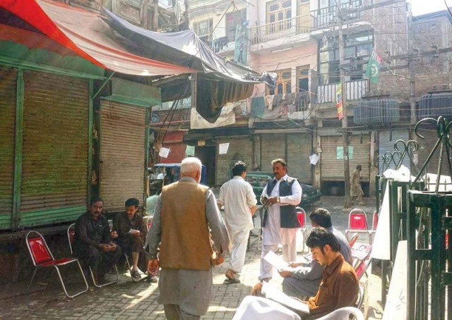 fish traders set up camps outside their shops in ghanta ghar in the city photo express fish traders set up camps outside their shops in ghanta ghar in the city photo express