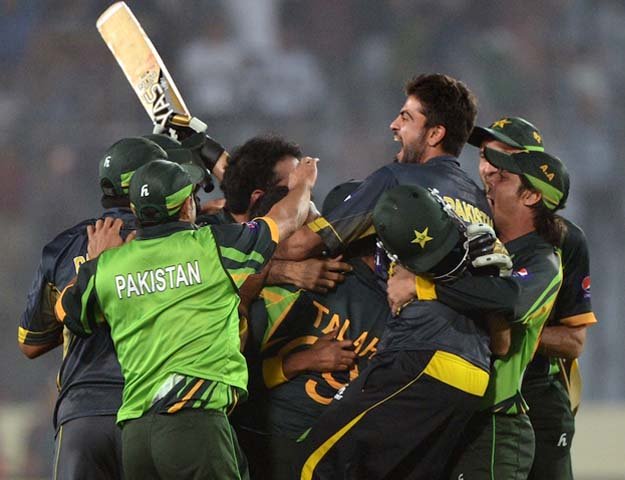 shahid afridi is mobbed by his team mates in asia cup encounter between pakistan and india at mirpur on march 2 2014 photo afp