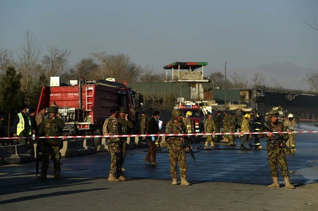 afghan security personnel stand guard as firefighters clean the site of a suicide bombing near the gate of ministry of defence in kabul on february 27 2016 photo afp afghan security personnel stand guard as firefighters clean the site of a suicide bombing near the gate of ministry of defence in kabul on february 27 2016 photo afp