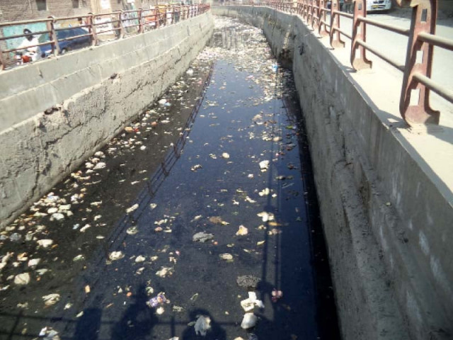 a nullah runs through supply road area in the city photo express a nullah runs through supply road area in the city photo express