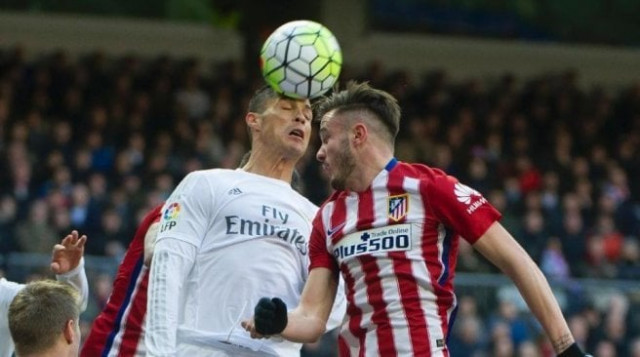 real madrid forward cristiano ronaldo l vies with atletico madrid midfielder saul niguez during the spanish league football match real madrid cf vs club atletico de madrid at the santiago bernabeu stadium on february 27 2016 photo afp