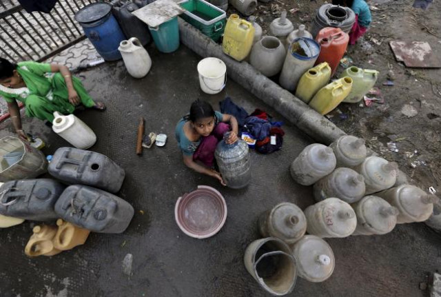 a girl waits to fill water in her containers from a municipal tap in new delhi india february 21 2016 photo reuters a girl waits to fill water in her containers from a municipal tap in new delhi india february 21 2016 photo reuters