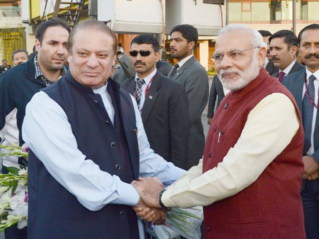 pm nawaz sharif shakes hands with his indian counterpart narendra modi upon latter 039 s arrival at the allama iqbal international airport in lahore on december 25 2015 photo pid