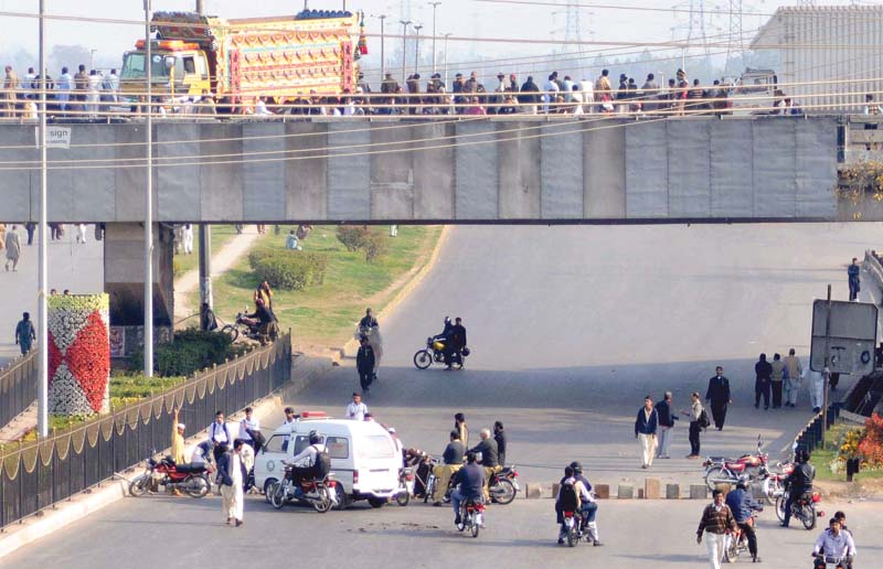 protesters block faizabad interchange on the islamabad expressway after mumtaz qadri s execution while rangers stand alert nearby photos agha mehroz express