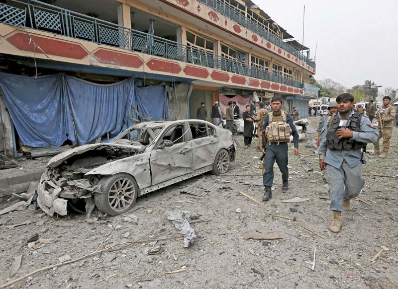 policemen inspect the site of a blast near the indian consulate in jalalabad photo reuters