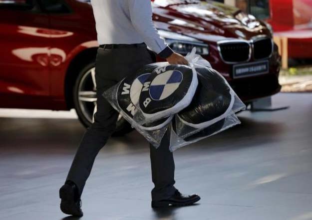 a dealer carries bmw 039 s promotional cushions at a dealer shop in beijing china september 11 2015 reuters